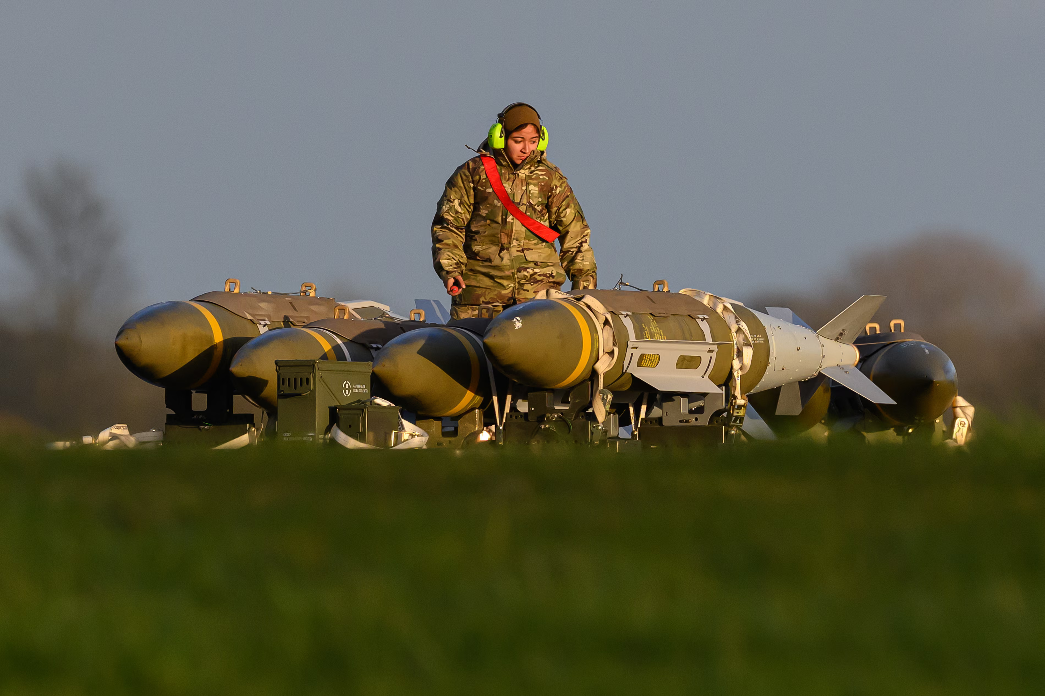 A member of the ground crew works with ordnance.