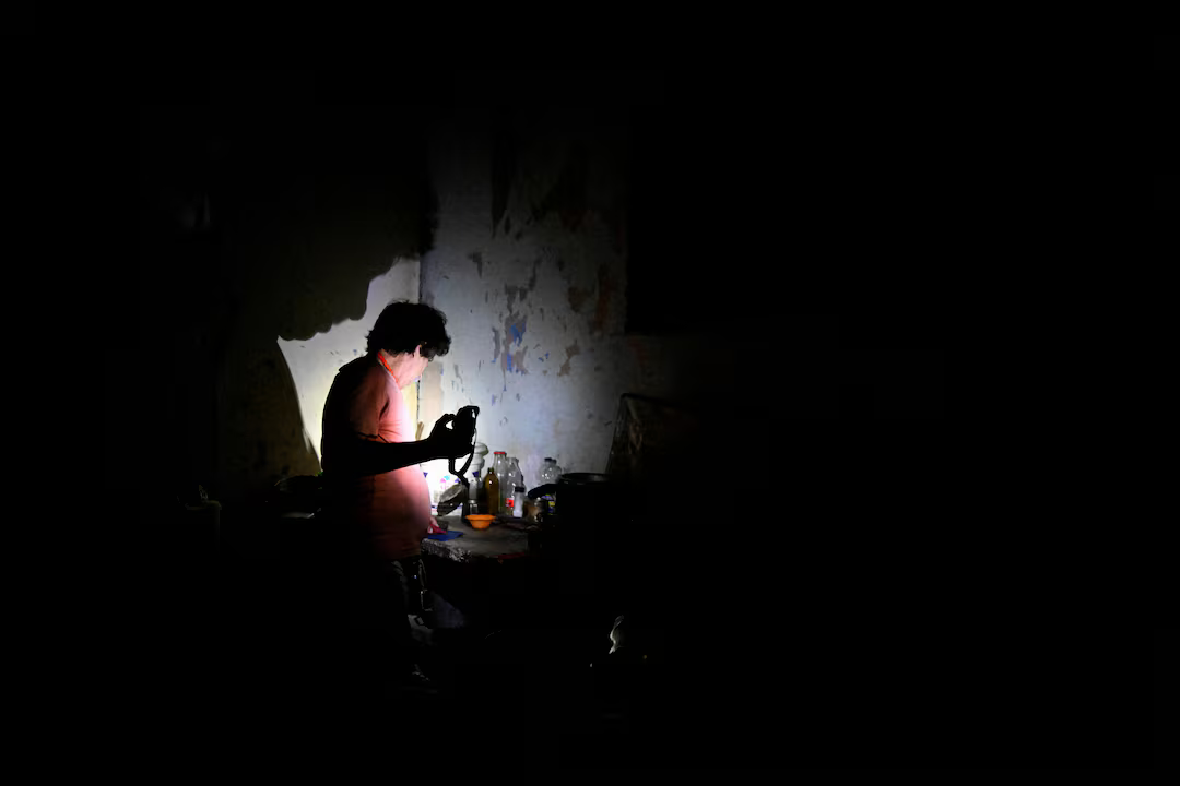 A man uses a flashlight during a blackout after Cuba's national electric grid collapsed, leaving around 10 million people without power amid a U.S.-imposed oil blockade, in Havana, Cuba, March 16. REUTERS/Norlys Perez