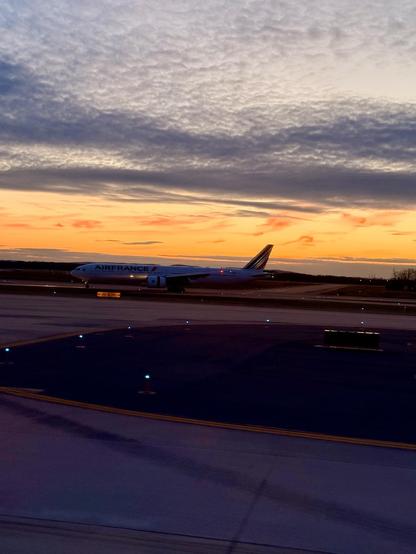 A wider shot of the same AirFrance plane and sunset