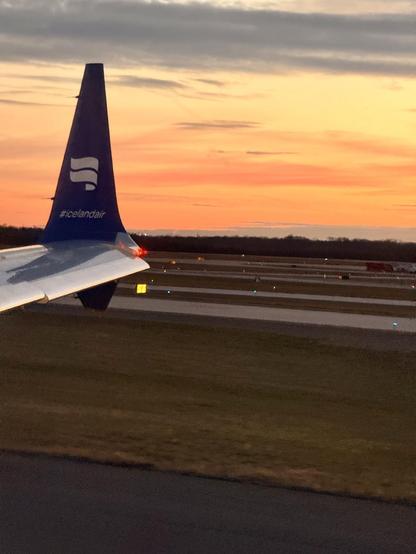 The wingtip of the Icelandair plane with a nice sunset in the distance