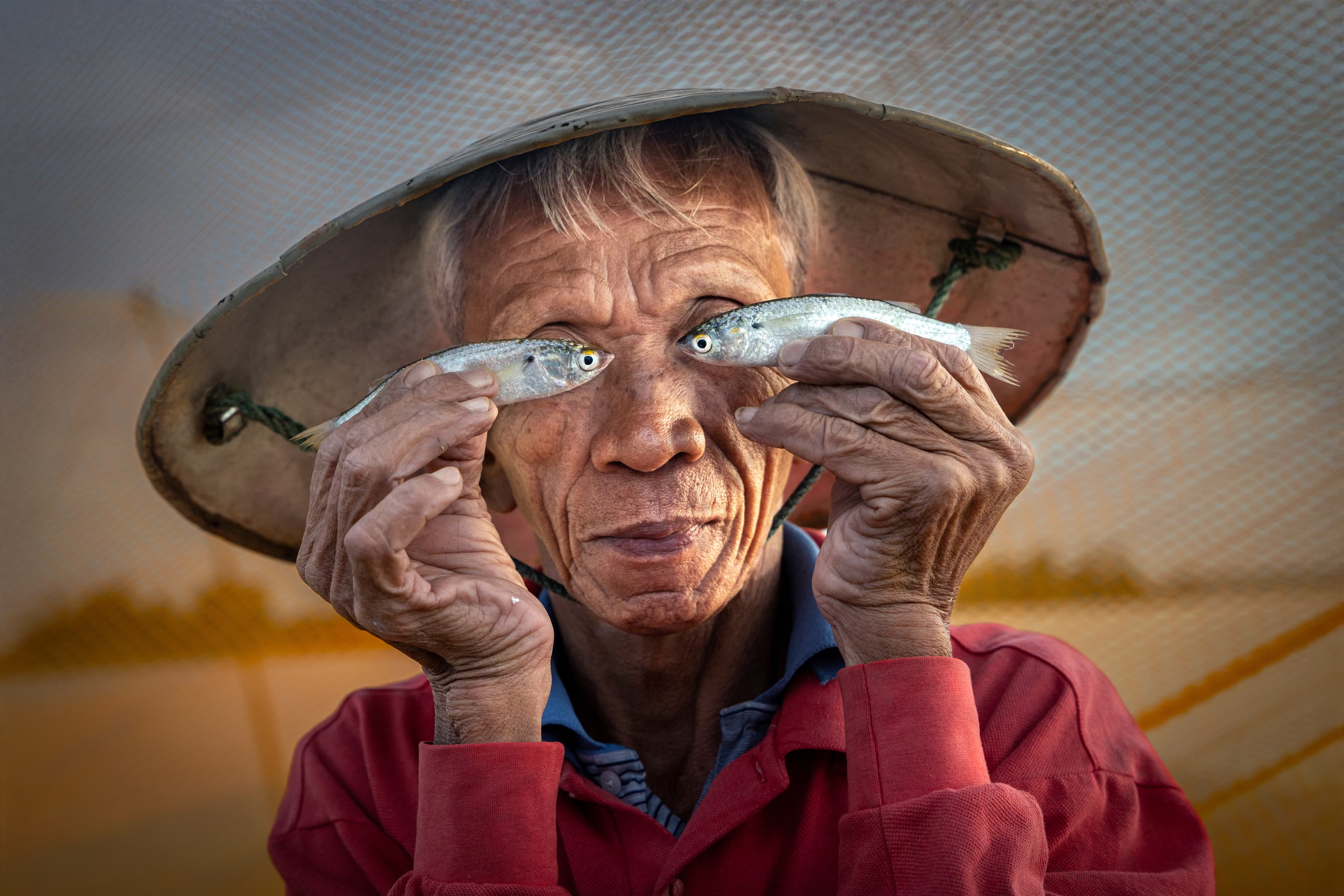 Fish eyes – overall winner
The overall first prize winner is Sophia Spurgin, a UK-based retired teacher, with her humorous portrait of a fisher captured spontaneously on a boat in Hoi An, Vietnam. Spurgin said: ‘I was keen to dedicate some time to serious travel photography during a family holiday and had been taking photos of this fisherman at work alongside a local photographer.’
Photograph: Sophia Spurgin