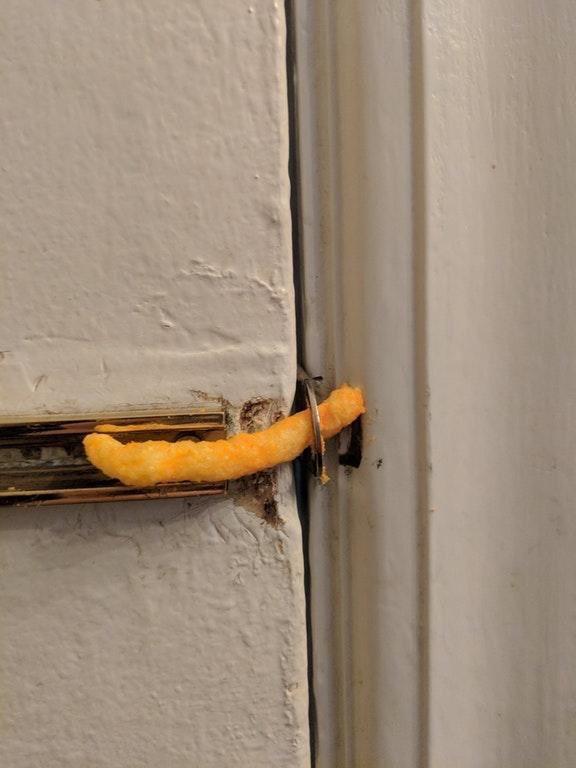 Cheese puff used as a door lock showing how fragile it is