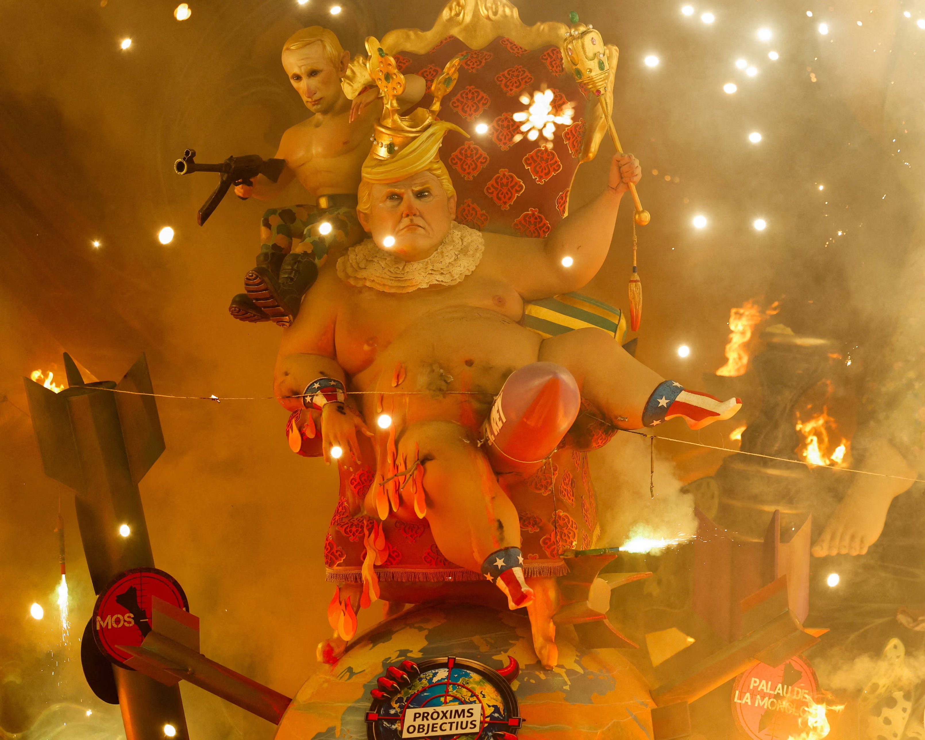 A sculpture depicting the US president, Donald Trump, and the Russian president, Vladimir Putin, burns on the last day of Fallas festival, which showcases satirical statues.