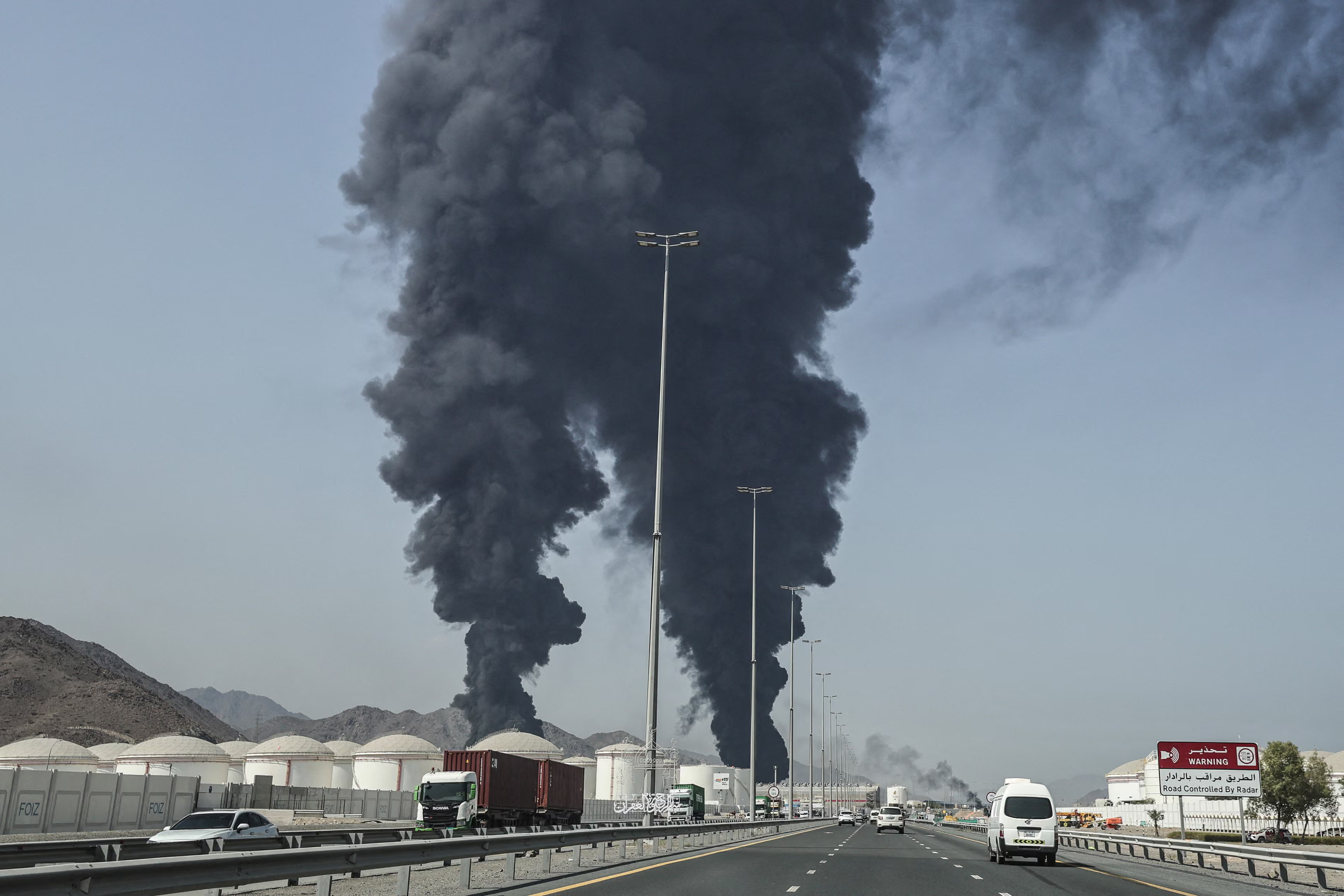 Smoke rises from the direction of an energy installation.