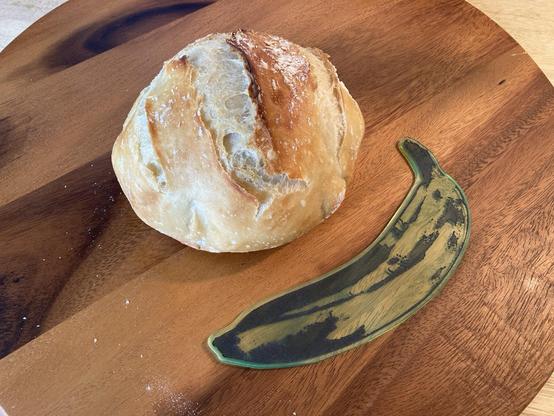 A loaf of bread with a laser-cut banana for scale.