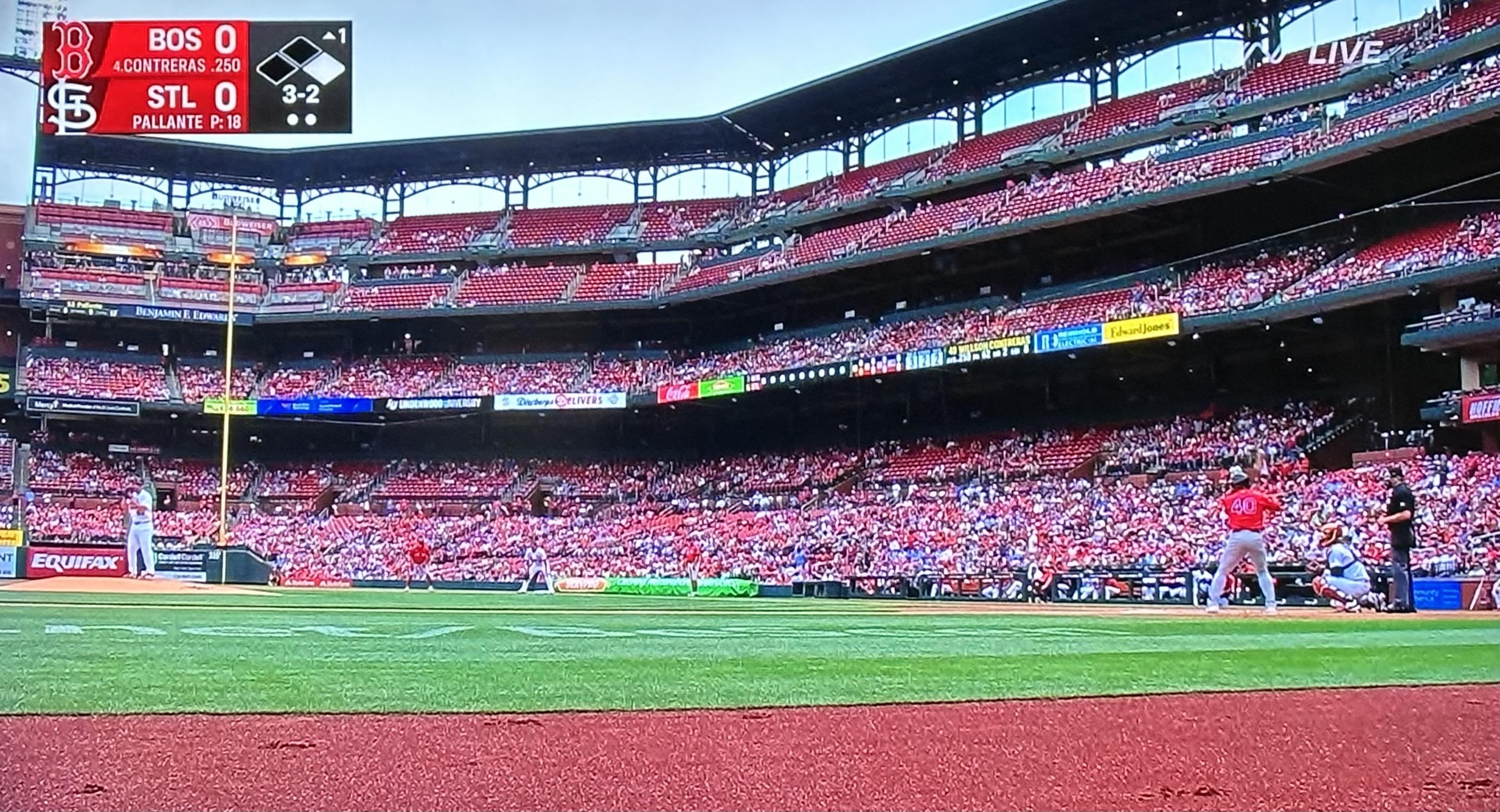 Camera shot showing a tiny pitcher and a tiny batter from the visiting dugout