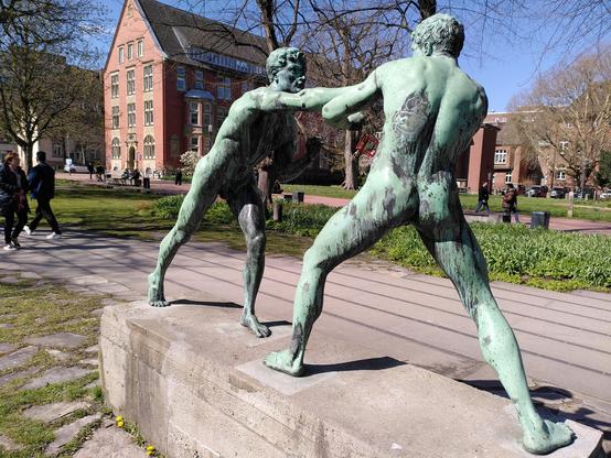 Neoclassical bronze sculpture group of two ancient Greek boxers. Both with a green patina. One is photographed from behind to capture his nice bum.