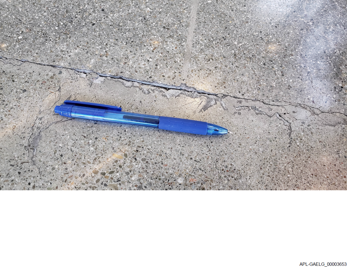image of crack in concrete floor with discovery BATES number