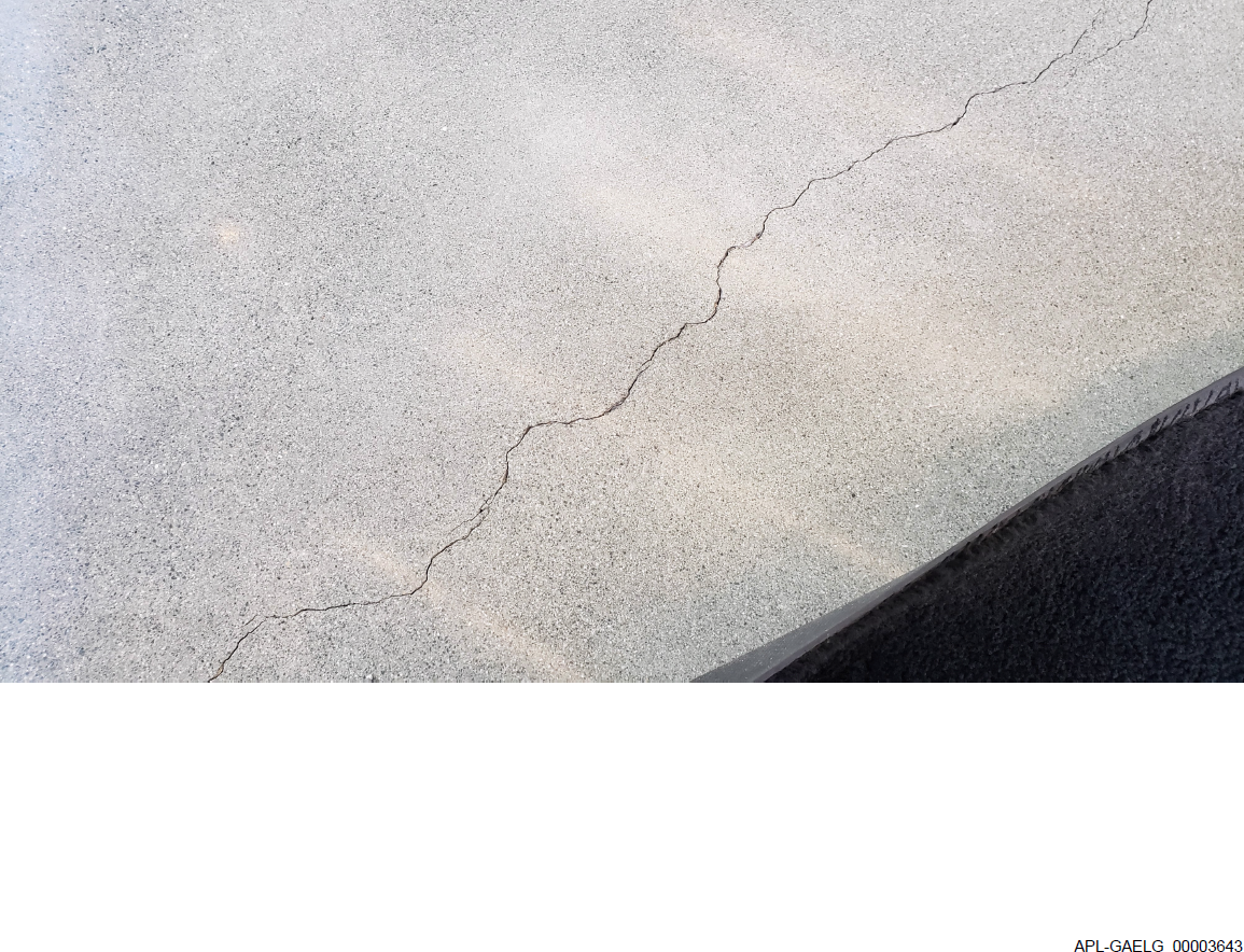 image of crack in concrete floor with discovery BATES number