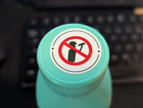The cork of the shampoo bottle has a sign that indicates that you 
either: Should not sing karaoke in the shower
or: Should not drink the shampoo
I lean towards the first option, since noone would drink shampoo anyways!