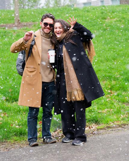 Man and woman happy because I gekkered at them.  he's on the left with a brown coat and sweater and she's got a matching scarf and black coat and pants.