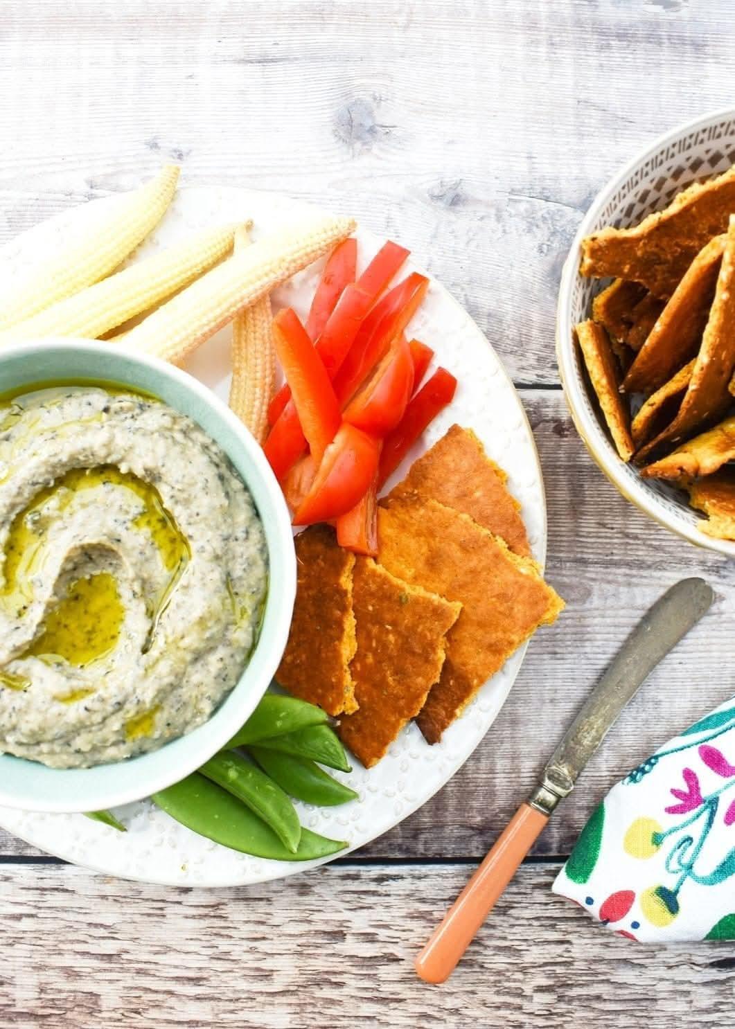 Bowl of pate served with crunchy veg and crackers.