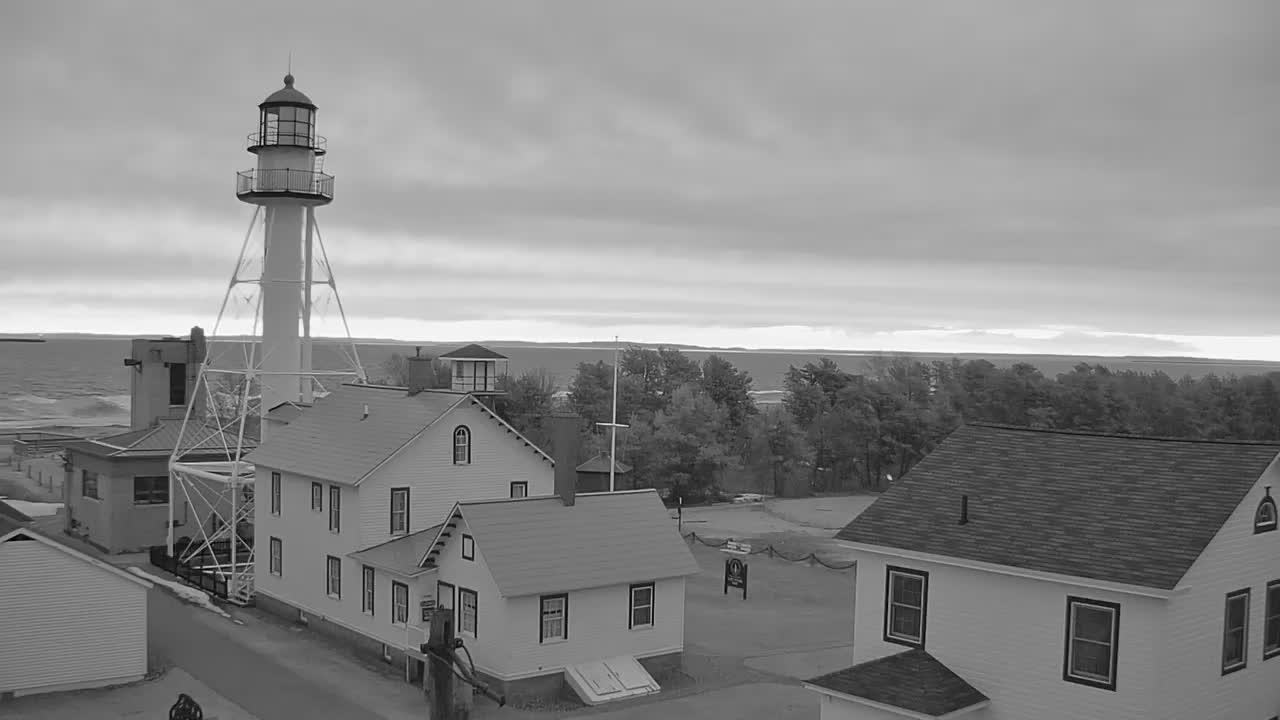 View looking NE from the Whitefish Point Lighthouse complex, with the lighthouse in the foreground looking over the shoreline of Lake Superior. // Image captured at: 2026-04-23 10:18:04 UTC (about 1 min. prior to this post) // Image sourced from: wmta.org // Current Temp in Whitefish: 39 F | 4 C // Precip: broken clouds // Wind: SE at 15 mph | 25 kph // Humidity: 81%