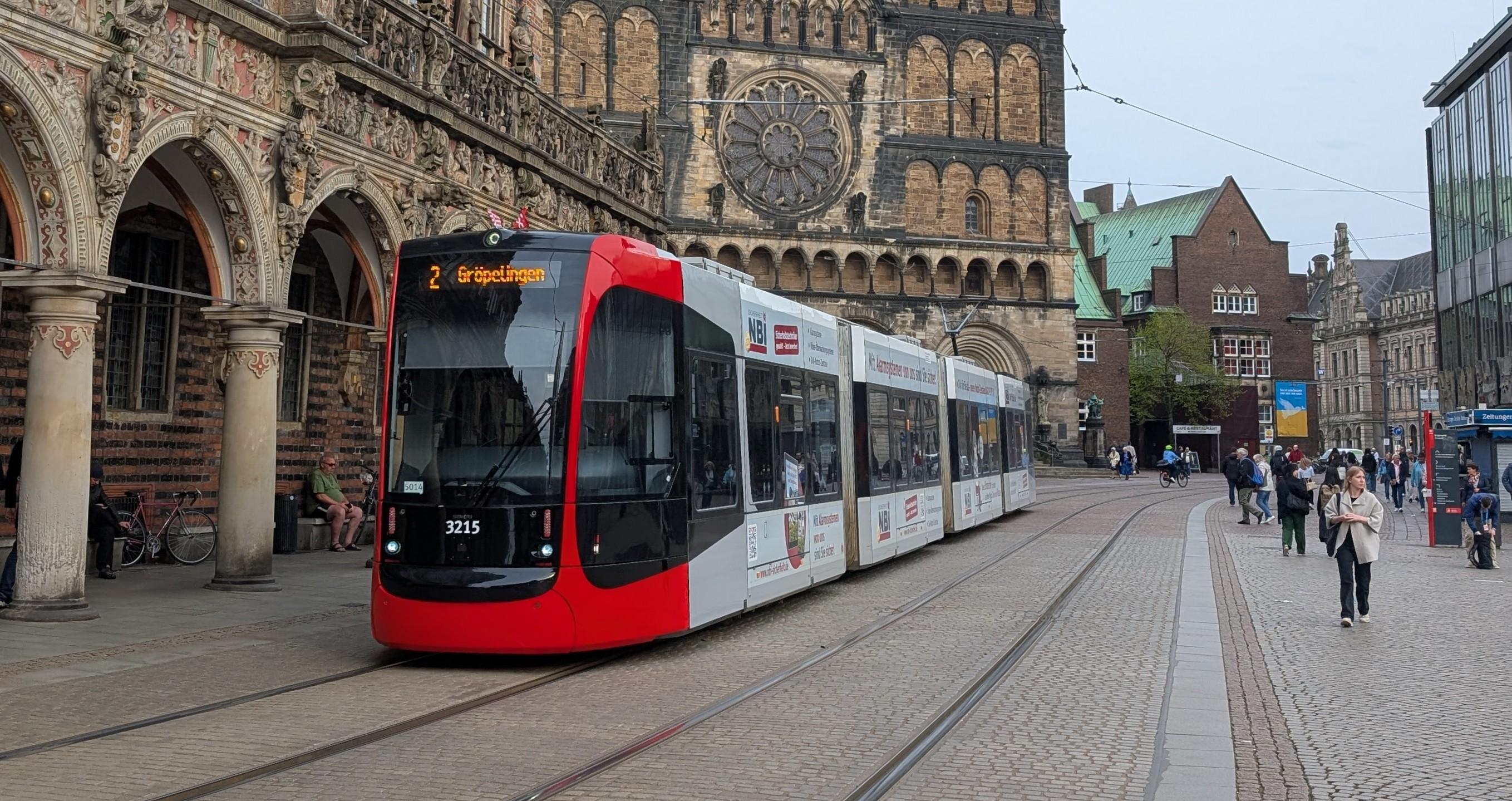 A BSAG GT8N-2 tram crossing Bremen Marktplatz, the historical townhall with arcades in the background