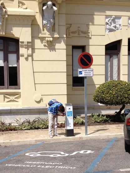 Person looking at an EV charging station