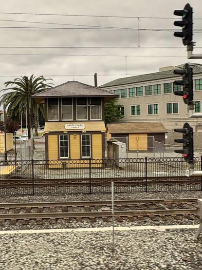 Old building alongside the train tracks that says Santa Clara Tower