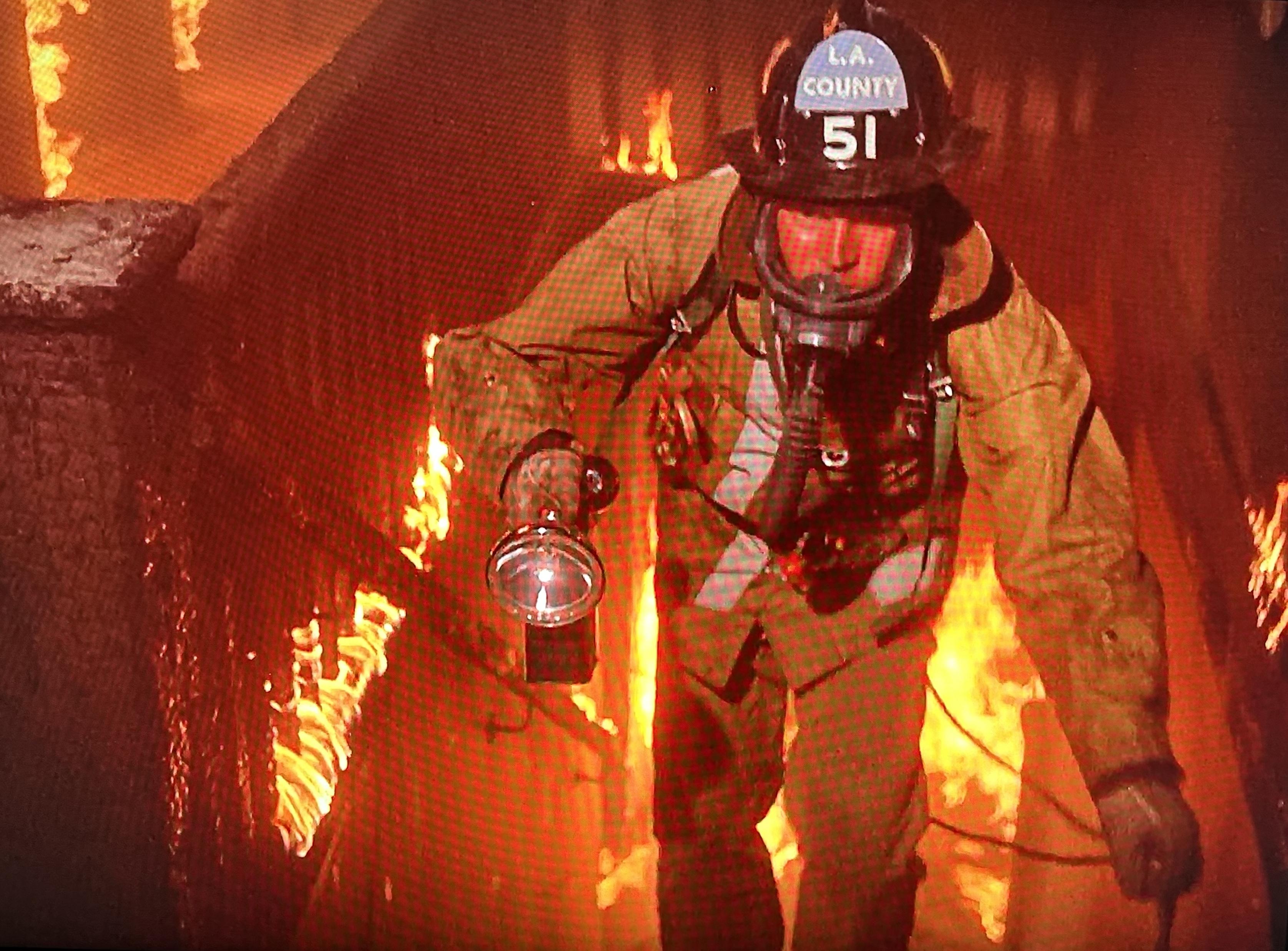 Fireman Roy DeSoto braves, flaming stairs, inside the home, searching for a boy and his dog