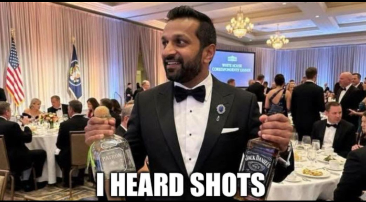 Kash Patel at the correspondents dinner, in his tux happily holding a bottle of taquila in one hand, whisky in the other. The caption reads « I heard shots »