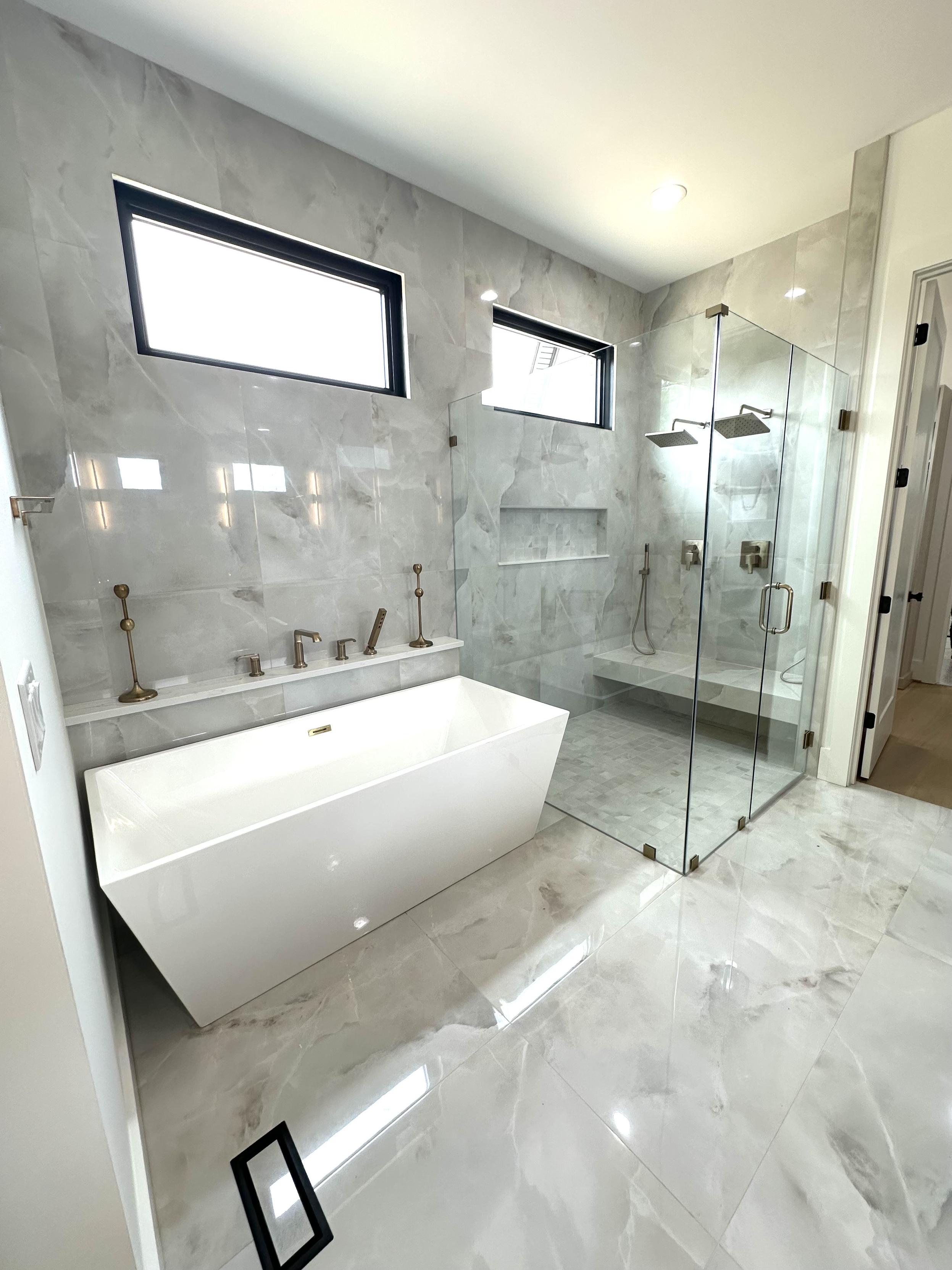 The master bath with a giant soaking tub and all glass walk in shower big enough for ten people.