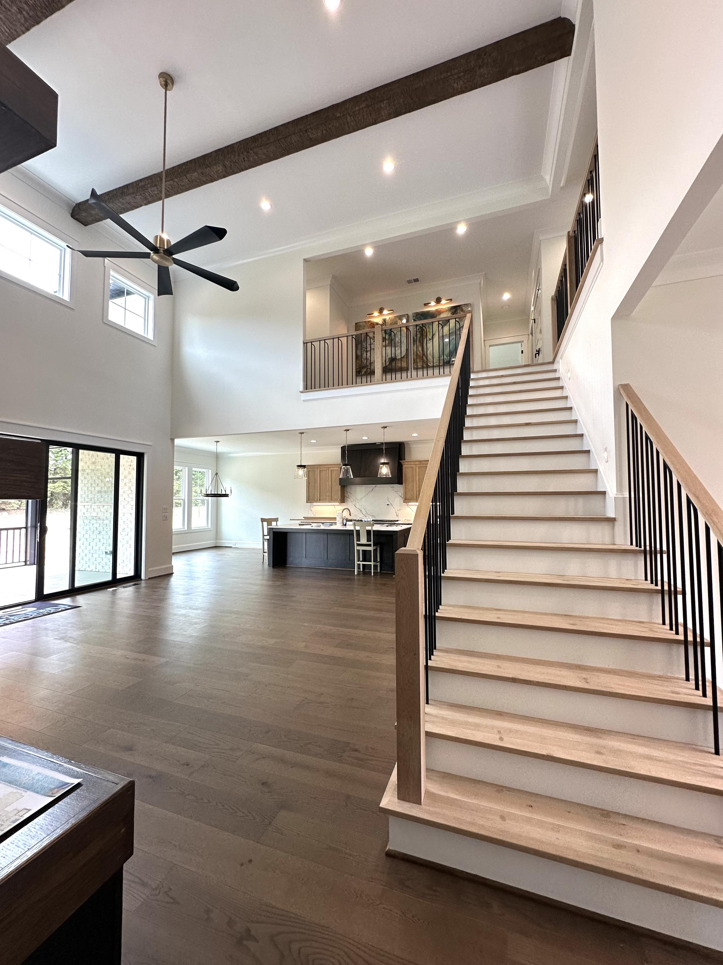 Looking up from the great room to the second floor. Gorgeous modern banister leads upstairs.