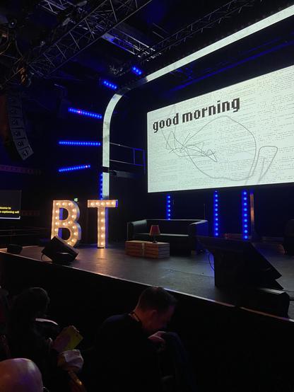 The stage at beyond tellerrand, with the letters B and T illuminated by light bulbs and the word good morning on the screen 