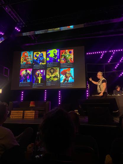 James showing eight of the cards of his superhero cardboard game 