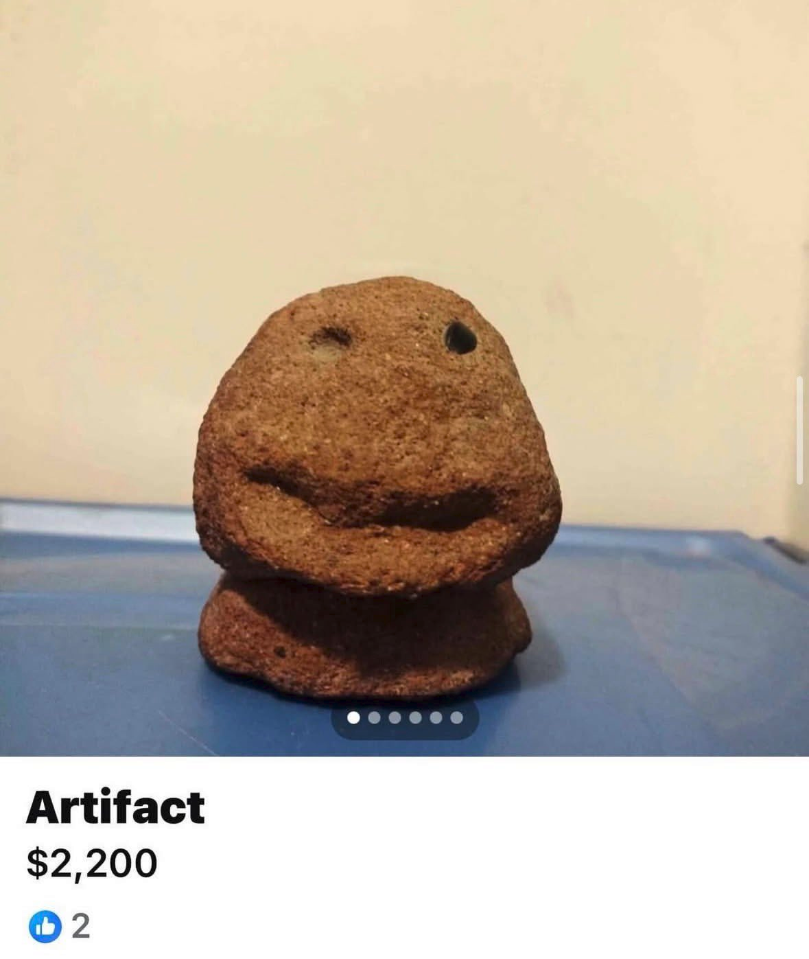 Facebook Marketplace listing of a brown faced object just called "Artifact" It sort of looks like a melted version of Sackboy from Little Big Planet