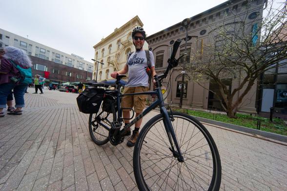 Man on with bicycle on ithaca commons