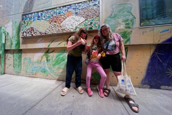 Two children with caretake in alley off Ithaca Commons