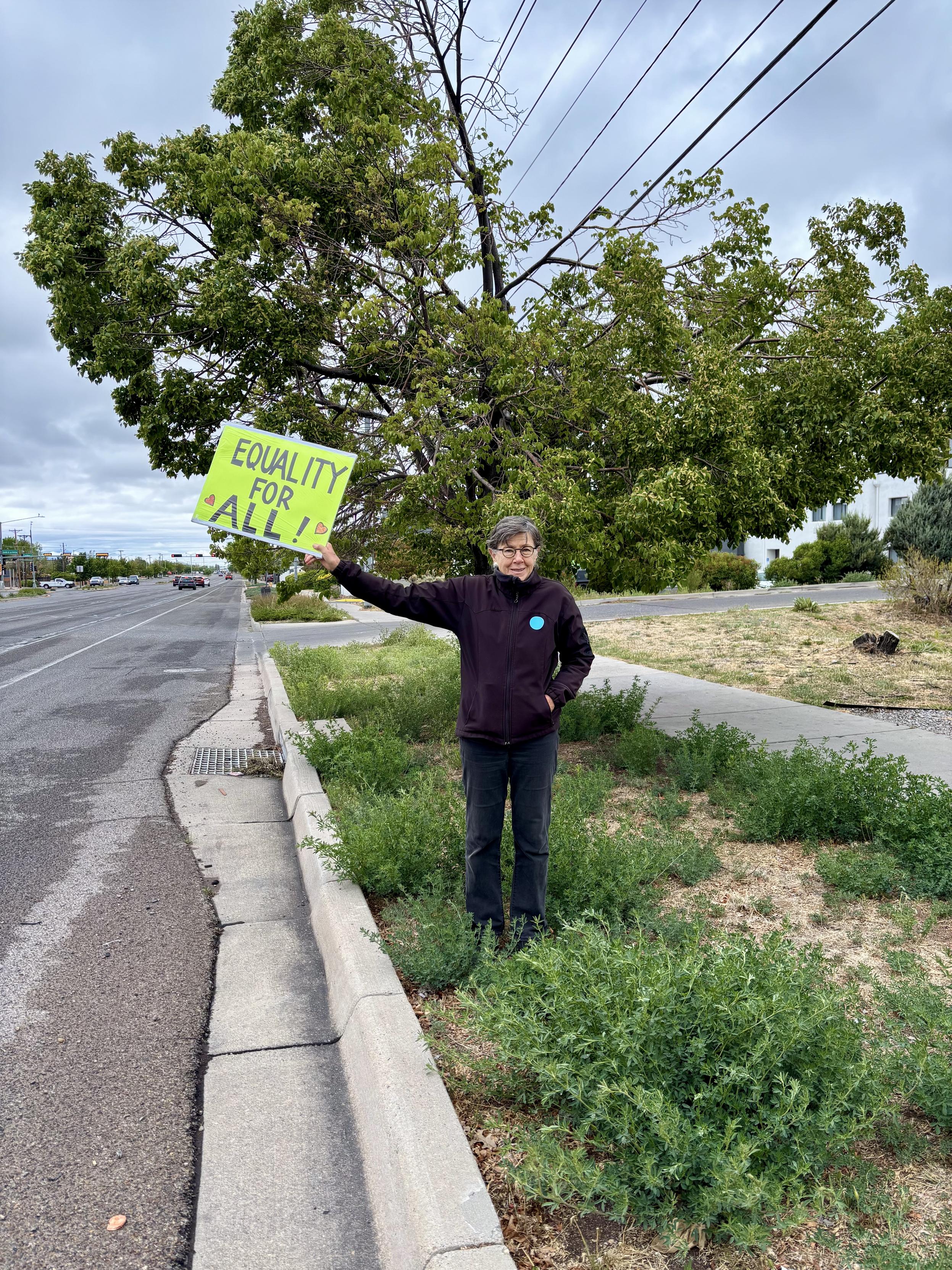 Protester with sign saying EQUALITY FOR ALL.