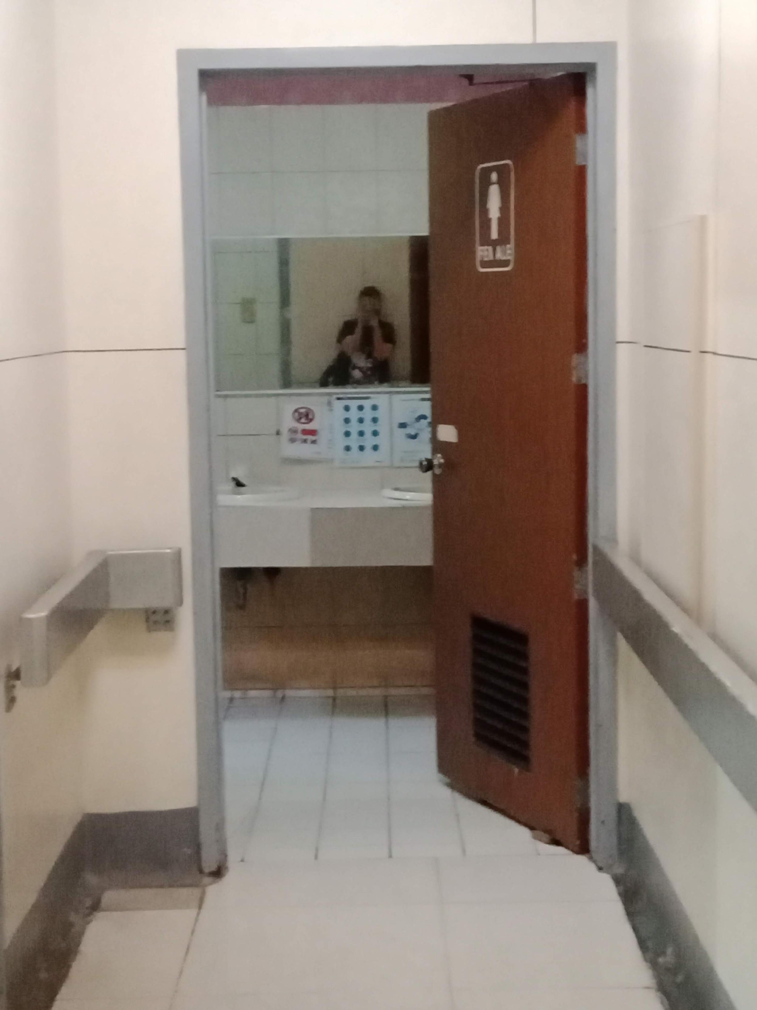 This image shows the entrance to a public restroom facility designed with accessibility features.