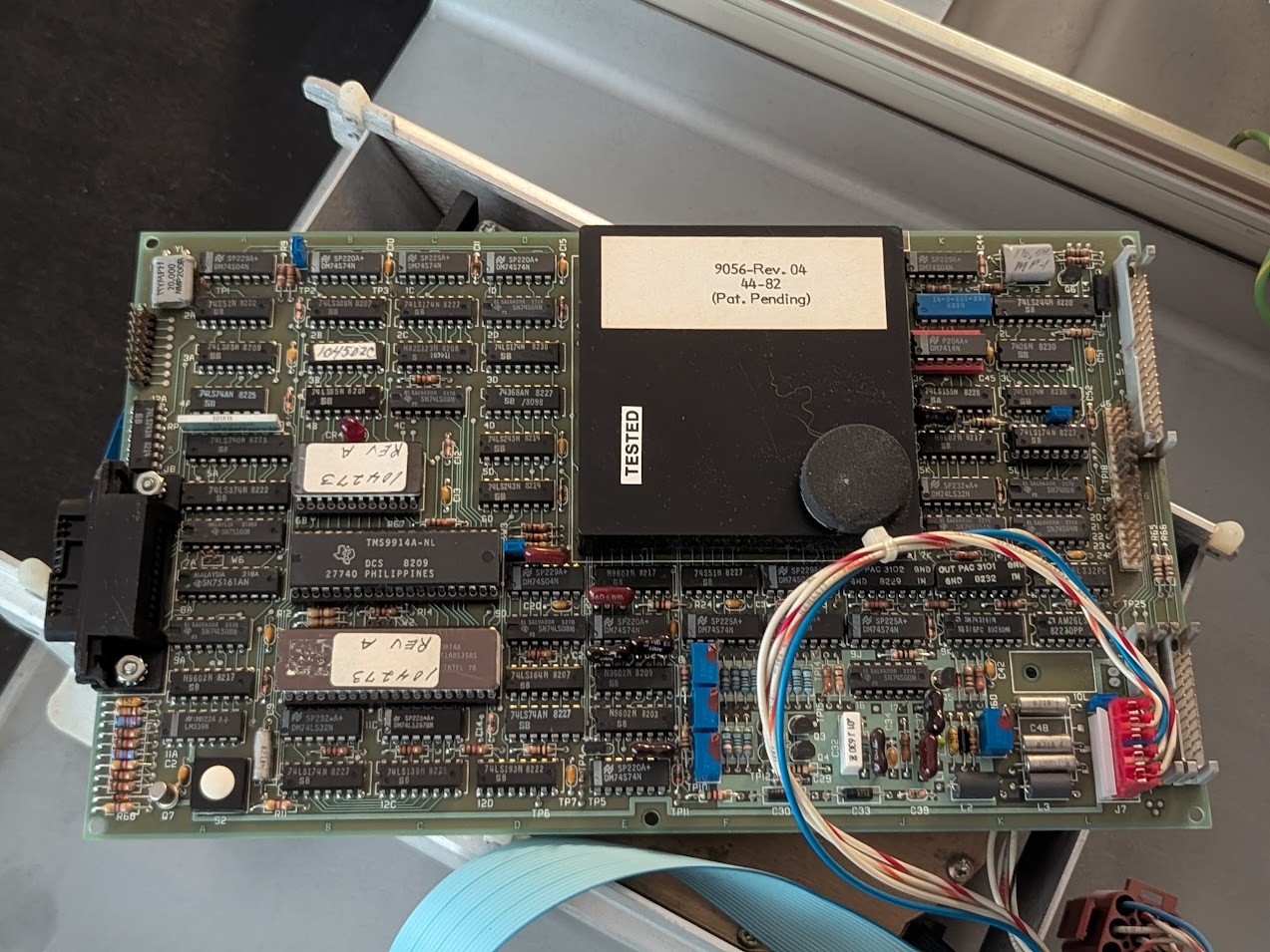 board about the size of a sheet of paper with a large black potted electronics module on top. it reads "9056-Rev. 04   44-82   (Pat. Pending)"