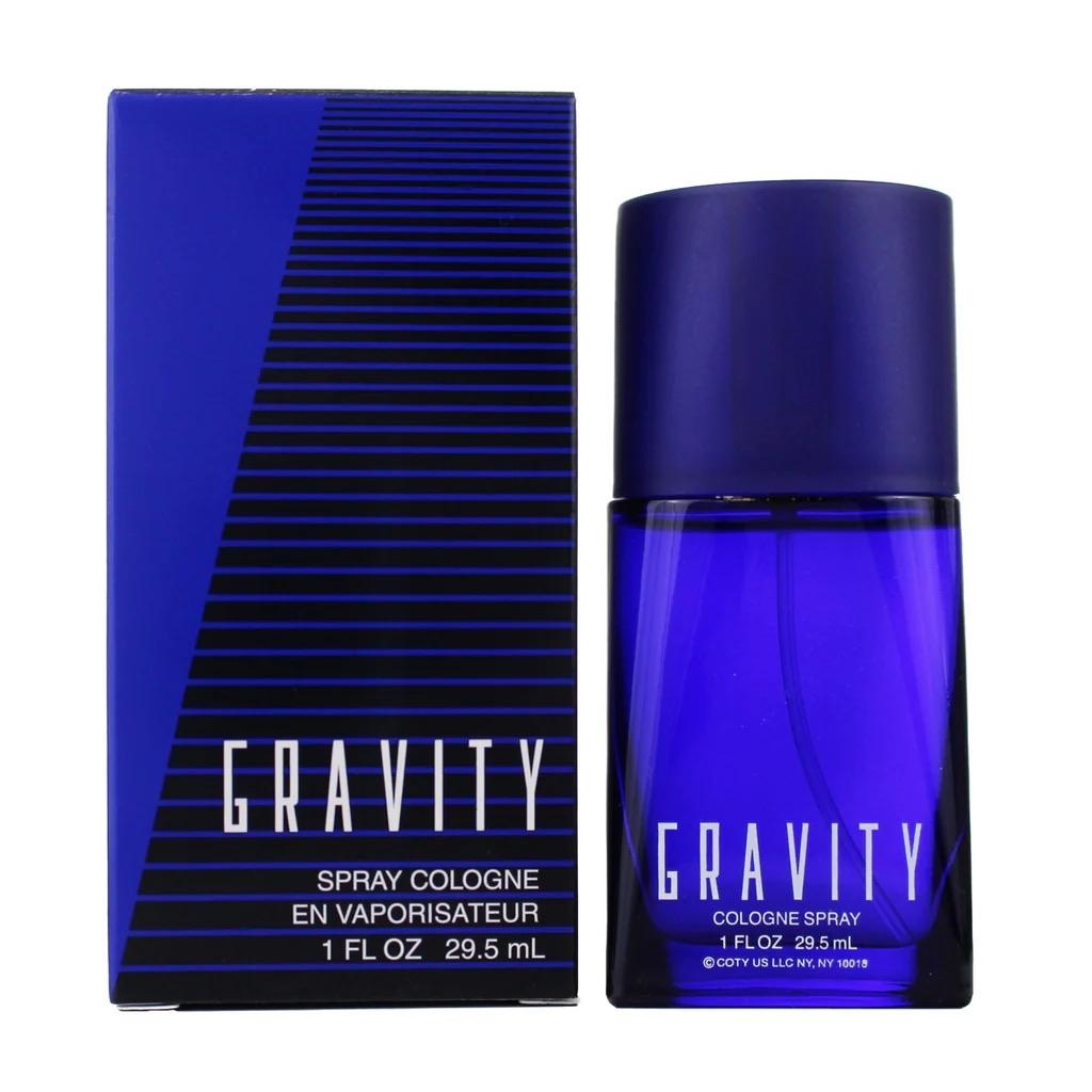 A blue cologne bottle with a black and blue striped box. The label reads "GRAVITY" and indicates it is a 1 fl oz (29.5 mL) spray cologne.