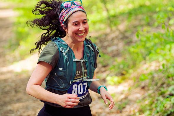 Moan running with curl hair tired up behind headband