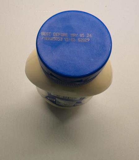 Mayonnaise bottle viewed from the cap end, featuring a best before date of May 5, 2024