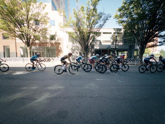 Bicyclists stream past on a closed street in Clarendon 