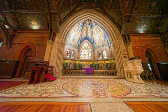 Inside out dome with ornate windows and decorations is behind a rectangle with a circle inscribed inside and outside with geometric patterns