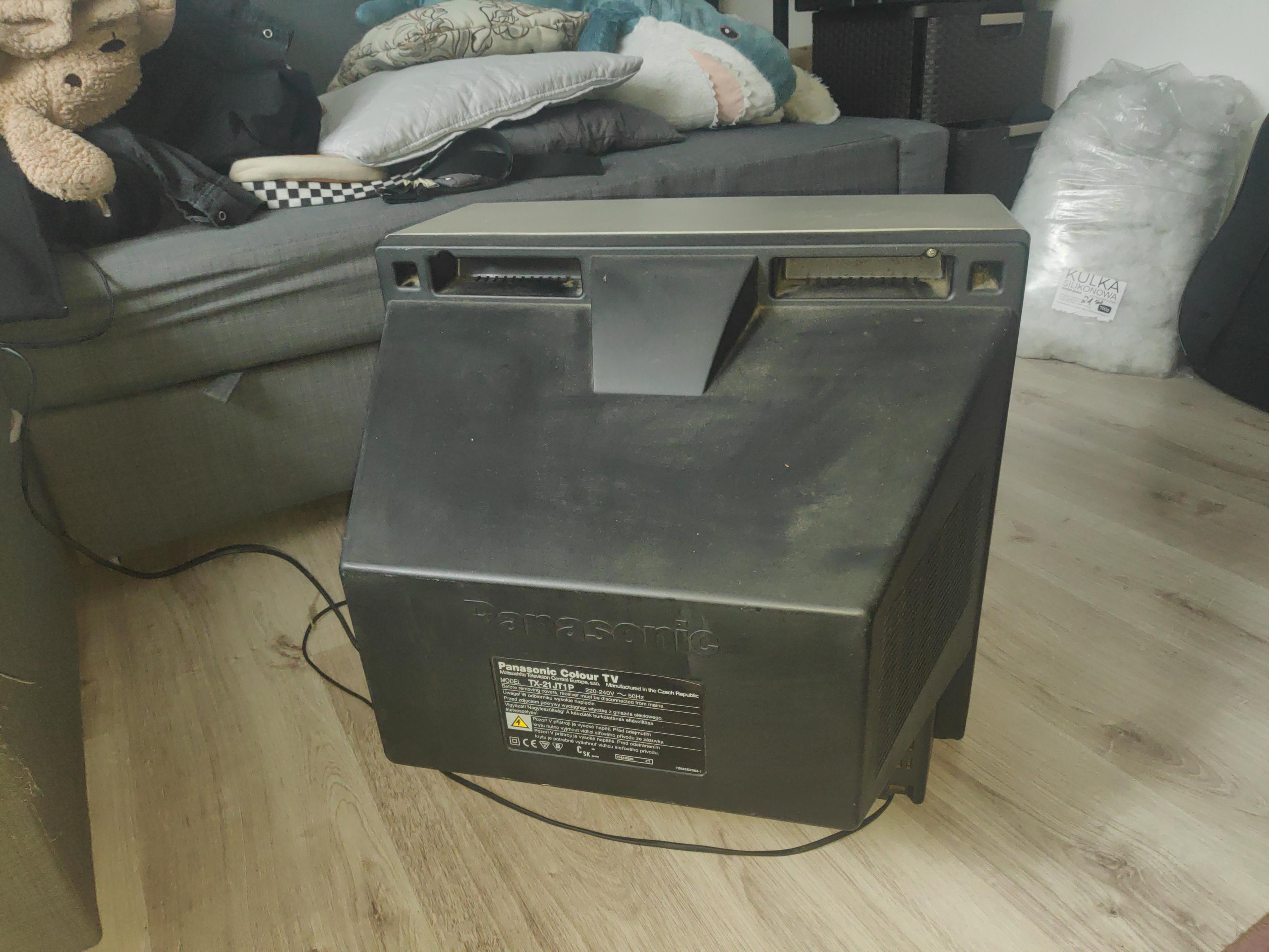 Here is the back view of the TV. There can be blåhaj seen on the messy bed in front of the TV.
