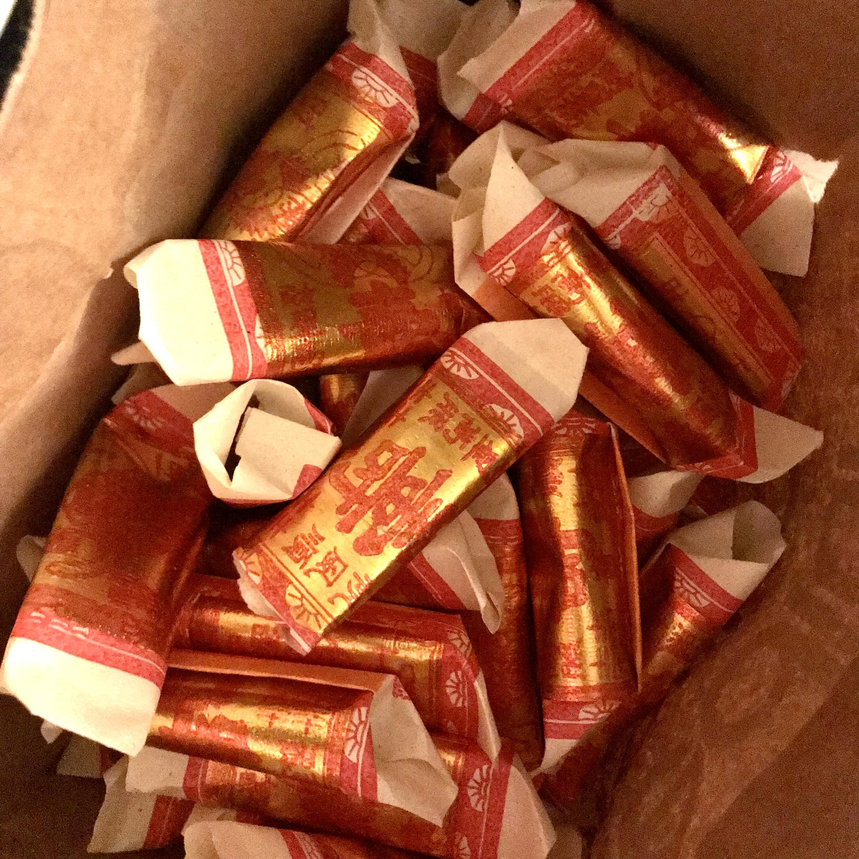 folded origami paper covered in gold paint and Chinese characters