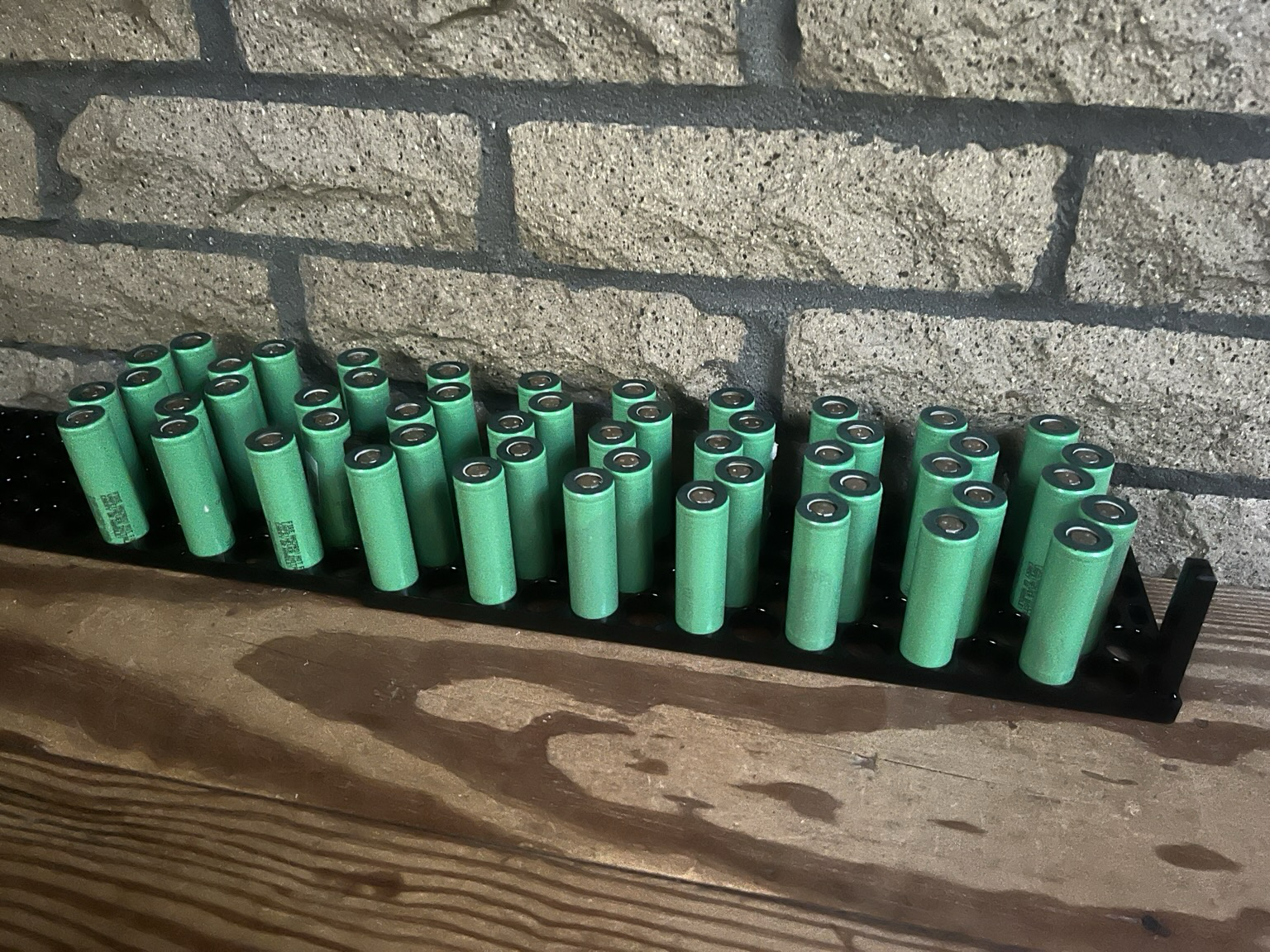 10 rows of 5 cells standing in loosely spaced rows in plastic cell holders