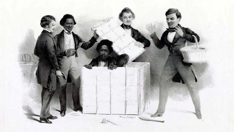This historical lithograph print is titled "The Resurrection of Henry 'Box' Brown at Philadelphia". It depicts the famous 1849 escape of Henry Box Brown, an enslaved Black man who successfully won his freedom by mailing himself inside a wooden shipping crate from Richmond, Virginia, to abolitionists in Philadelphia. Brown is shown in the center coming out of the crate. Behind him a white man is holding the lid of the crate. To the left a black man also has a hold of the crate lid with his left hand. There is a white man standing to the far left. On the far right is a white man with basket. All four men are looking at Brown coming out of the box.