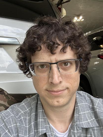 selfie of myself looking forwards with the piercings just visible on either side of my head