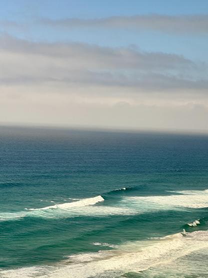 View of the Pacific Ocean with breaking waves from the northbound Amtrak Coast Starlight north of Santa Barbara.