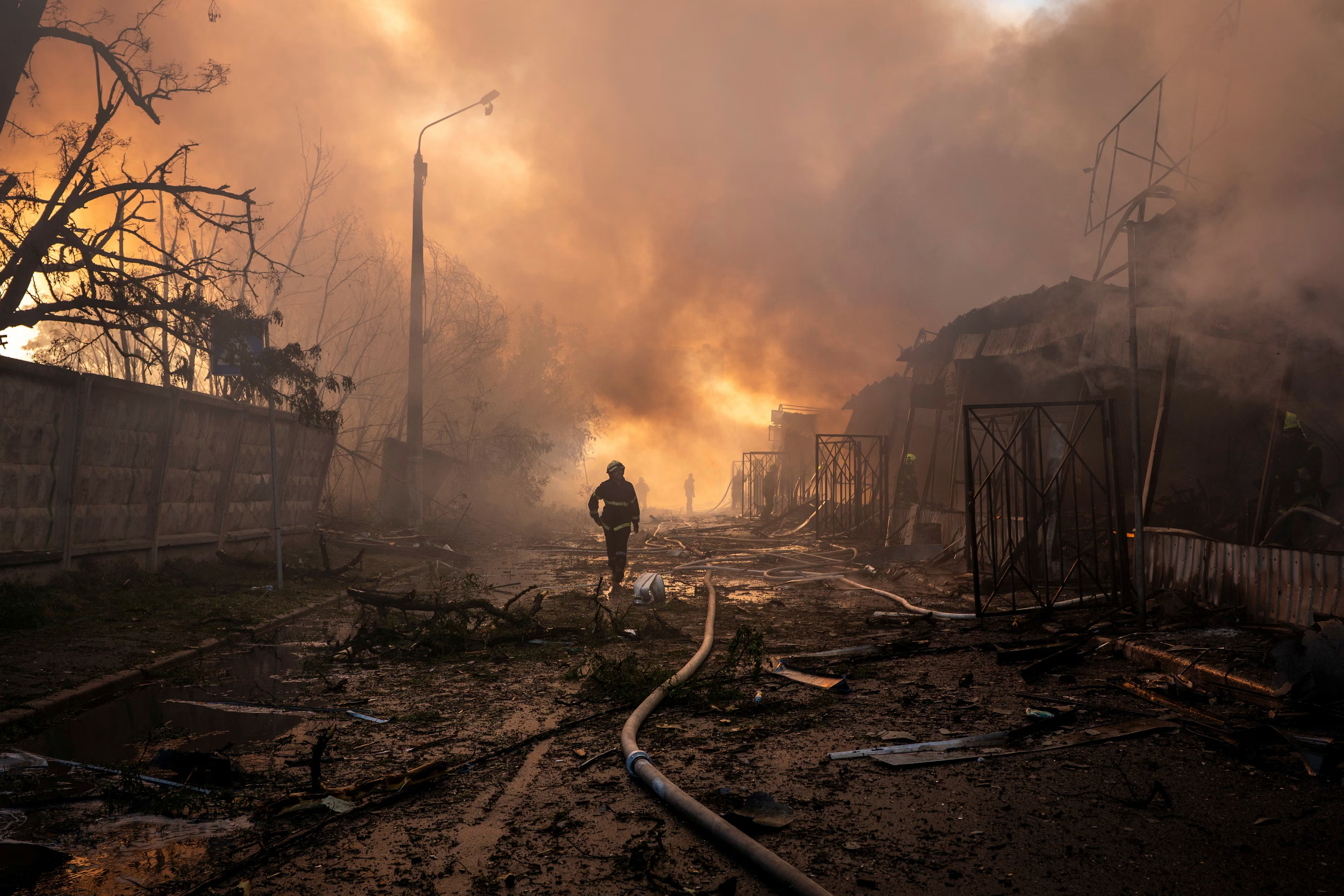 Kyiv, UkraineFirefighters try to put out a fire at a city marketplace following a Russian missile and drone attack in Kyiv. Photograph: Dan Bashakov/AP #photography #Ukraine #Kyiv #AltText