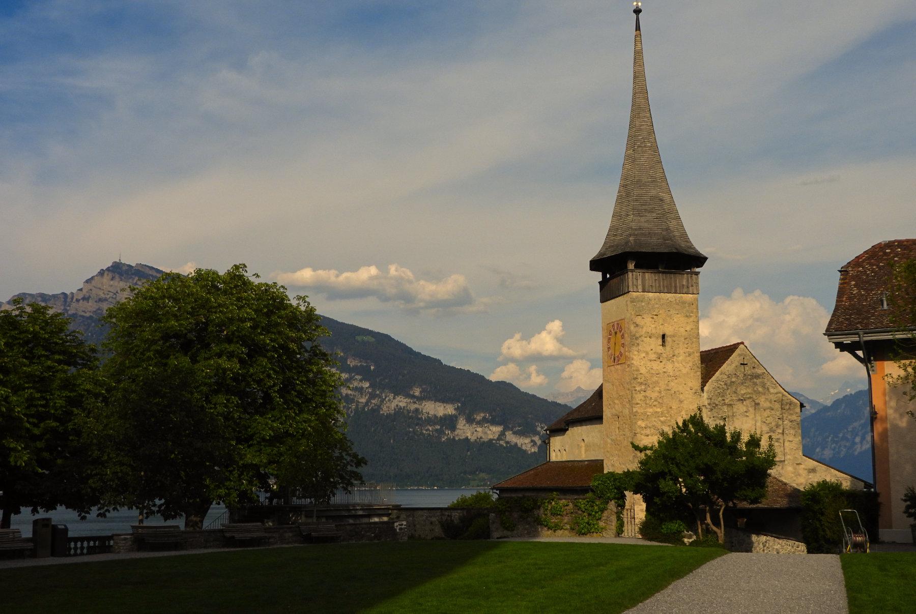 Castle church with lake and mountains beyond
