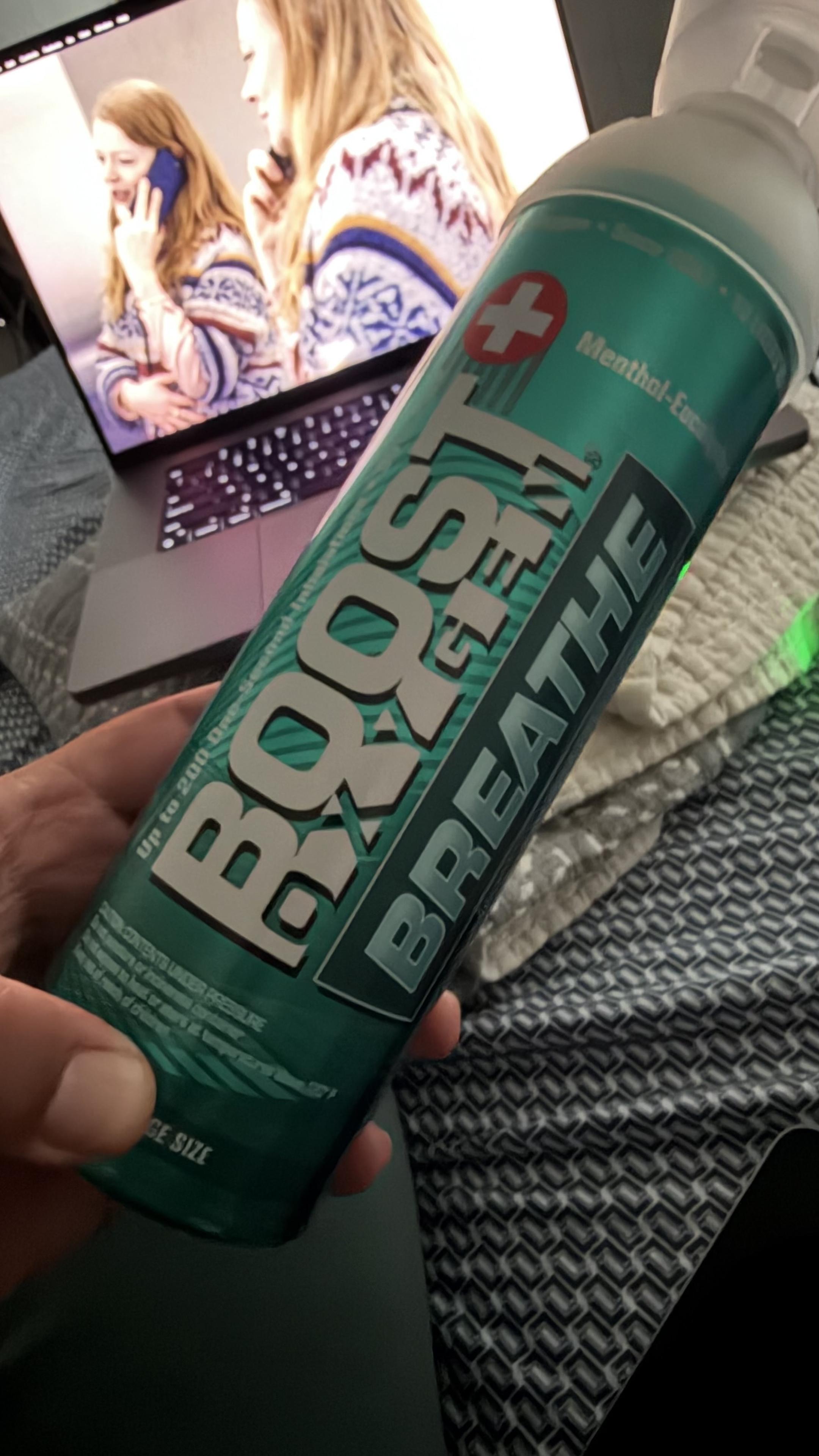Can of oxygen. Reads "Boost Oxygen". Laptop with Shiv in the background. 