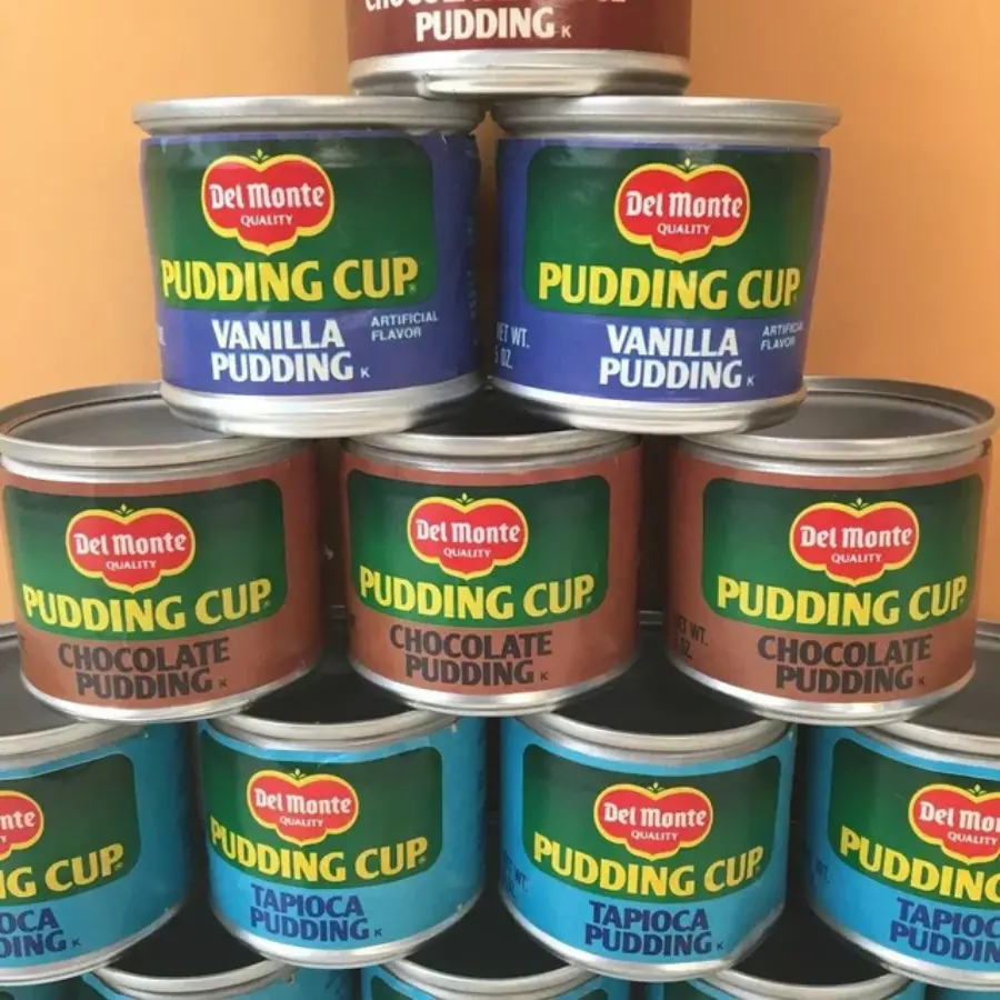 stacked pyramid of tin cans of Del Monte Pudding Cups