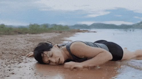 Schlussszene aus dem Film "Gravity": Dr. Ryan Stone (Sandra Bullock) hat es auf die Erde zurückgeschafft und wühlt enthusiastisch im feuchten Schlamm. 