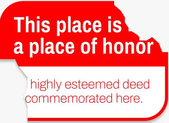 Slightly damaged nuclear waste warning sign that says: this place is a place of honor. Highly esteemed deed commemorated here.