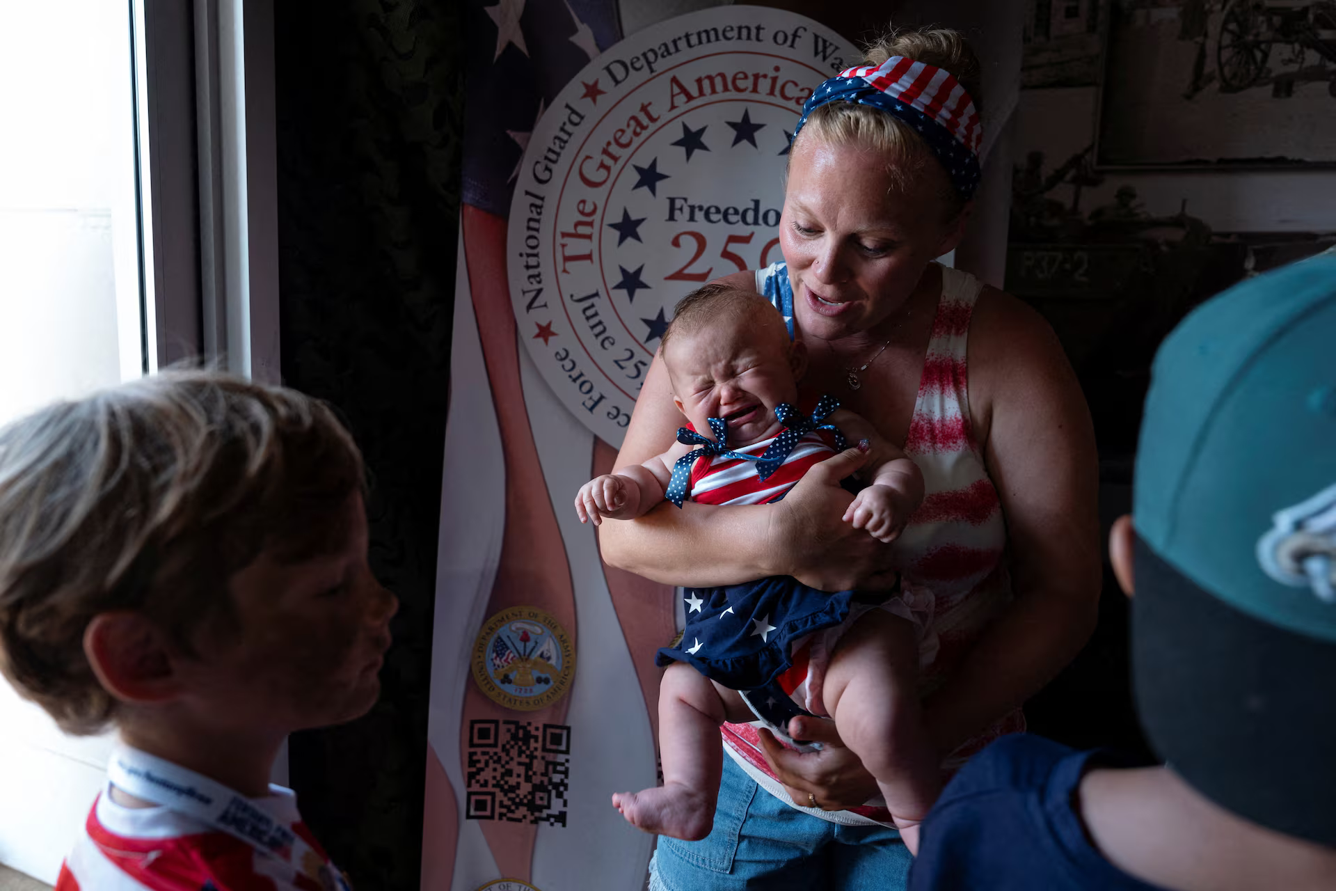 Charlotte Dettloff, 38, holds her three month old baby, Reagan, named after former U.S. president Ronald Reagan, in the U.S. Department of Defense booth at The Great American State Fair on the National Mall in Washington, June 29. REUTERS/Cheney Orr